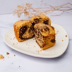 Pieces of freshly baked biscuit cake on a white plate