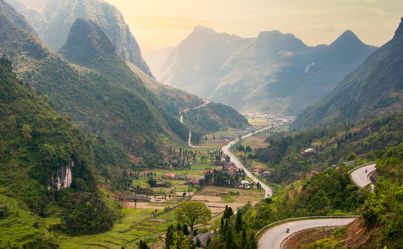 Winding Road Through Green Mountains at Sunset