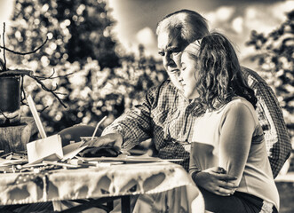 Fototapeta na wymiar Grandfather explains how to use laptop to his granddaughter.