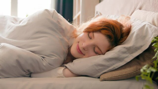 Caucasian happy woman sleeping in comfortable cozy bed at home girl lady asleep lying on soft pillow white linen orthopedic mattress resting relaxing napping healthy sleep nap in morning stress relief