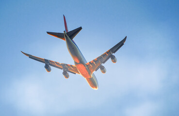 Airplane at low altitude departing from the airport at sunset.