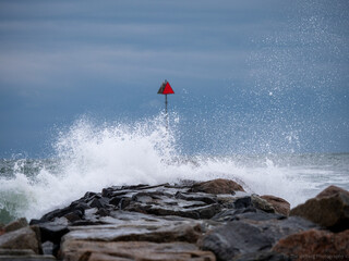 Fototapeta na wymiar Stormy waves at the Water Break in the harbor NH