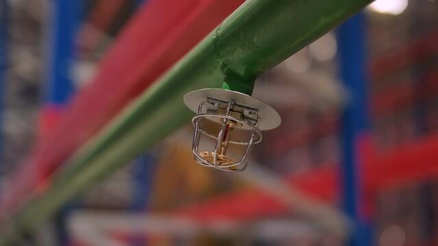 The water-based fire protection system is installed at a large factory. There is a pipe with a sprinkler.