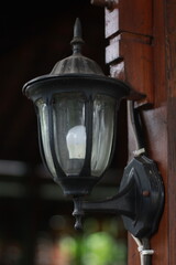 antique lamp on wooden wall