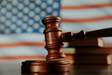 Judge gavel close-up and flag of United States of America. Law of USA concept. Violation of rights