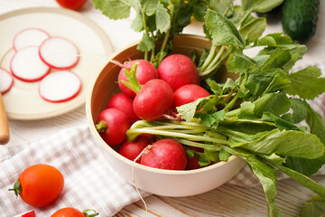 Radish and other spring vegetables on a wooden background, close-up.