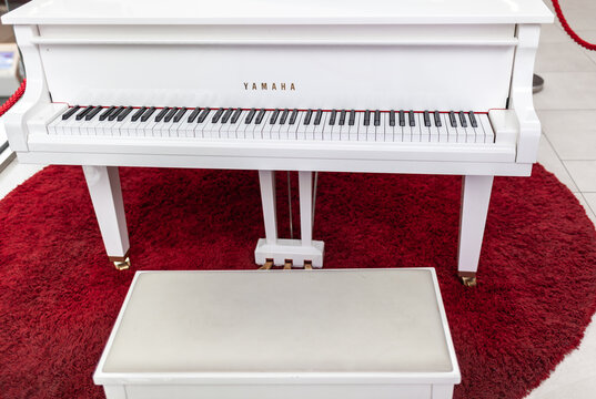12.03.2022, Moscow, Russia. A white grand piano in a shopping mall close-up. Image for design. Space for text.