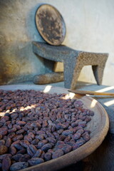Cacao beans being roasted on traditional comal clay plate
