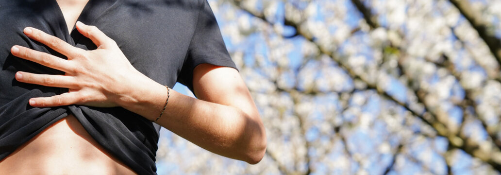An unrecognizable woman practice conscious breathing on the grass. Mindfulness for regulate anxiety and stress