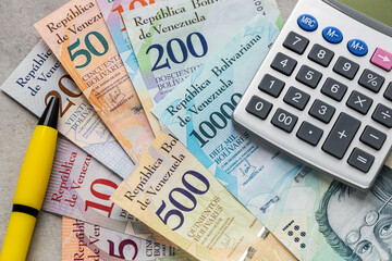 Venezuela money, calculator and pen, financial calculation concept, home budget