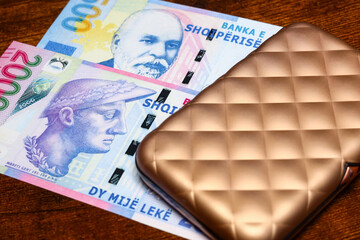 Albania money, leke currency and a beautiful gold wallet for cards and money