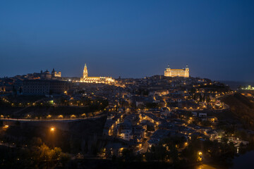 Toledo, Spain - April 9, 2023: Panoramic view of the city of Toledo at night, The Cathedral and The Alcazar