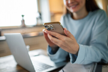 Young adult woman using her phone at home