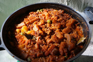 Sambal Goreng Krecek is a side dish to accompany opor or gudeg. It consists of krecek made from beef skin, petai, cowpea beans cooked with coconut milk and chili. Usually served during Eid al-Fitr    