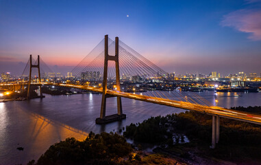 Fototapeta na wymiar Sunset on Phu My bridge, Saigon river, Ho Chi Minh city, Vietnam