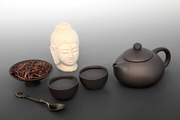 Kukicha twig herb green tea drink. Japanese ceremony with ceramic teapot set, Buddha statue....