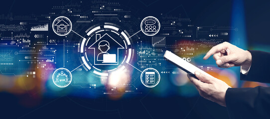 Remote Work theme with businessman using a tablet computer at night