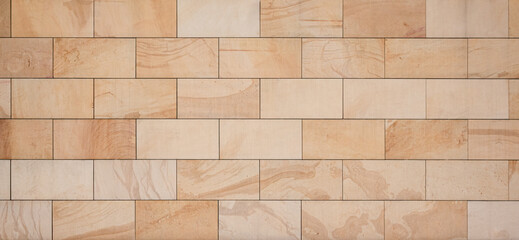 texture of a tiled beige stone wall as background, natural stone wall texture as background....