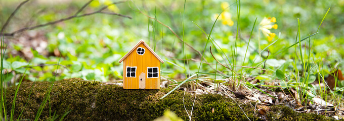 miniature house model on grass background