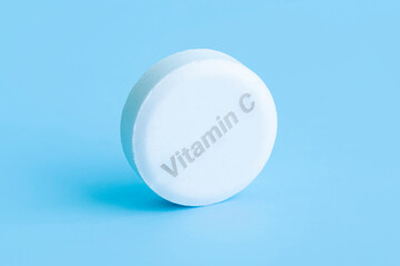 Multivitamin effervescent tablets. Soluble tablets of vitamin C. Calcium vitamin. Effervescent vitamin on a blue background. Medicine concept. Immunity. macro tablet