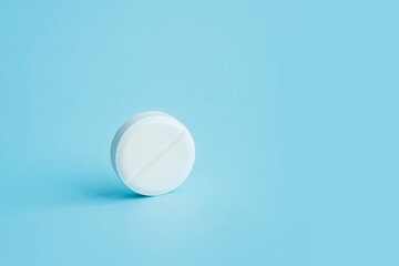 Pharmacy health care concept. Close up pill in on blue background.