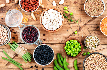 Legumes, beans and sprouts. Dried, raw and fresh, top view. Lentils, mung beans, chickpeas, soybeans, edamame, peas, Healthy diet food, vegan proetin, micronutrients and fiber sources, top view