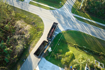 Aerial view of Hurricane Ian special aftermath recovery dump truck picking up vegetation debris...