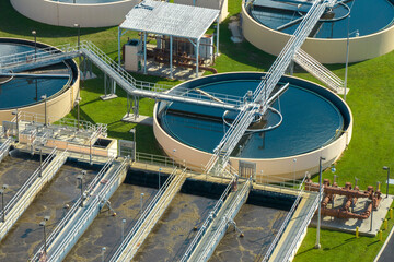Aerial view of modern water cleaning facility at urban wastewater treatment plant. Purification process of removing undesirable chemicals, suspended solids and gases from contaminated liquid - obrazy, fototapety, plakaty