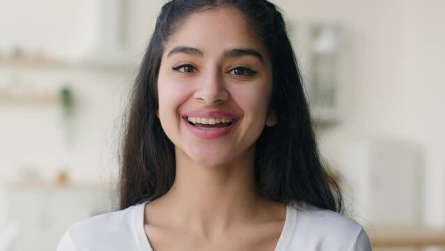 Portrait happy Indian Arabian woman ethnic girl carefree businesswoman student laughing funny joke joyful female homeowner smiling toothy dental smile sincere laugh humor joking fun surprise at home