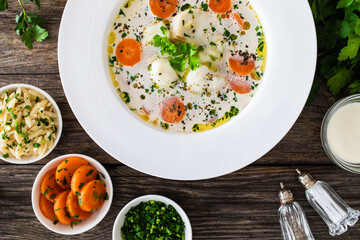 Fish soup on wooden table
