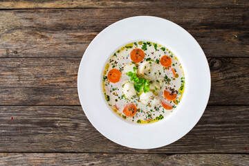 Fish soup on wooden table
