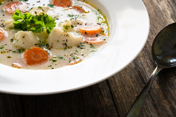 Fish soup on wooden table
