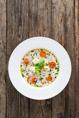 Fish soup on wooden table
