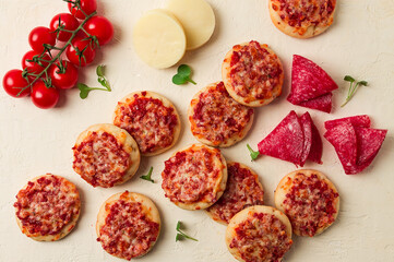 Mini pizzas, salami with mozzarella cheese, on a white table, top view, no people,