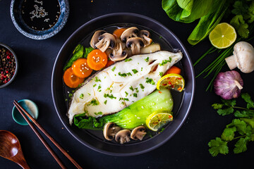 Fish soup on wooden table Asian style
