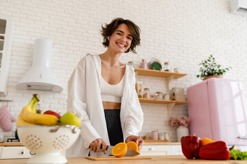 young pretty woman cooking at home, morning kitchen, healthy food