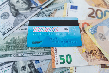 Top view credit card on money in various currencies. Dollars, euros. The global economic crisis. Currency basket. multi-currency card of payment system. exchange of money on stock exchange