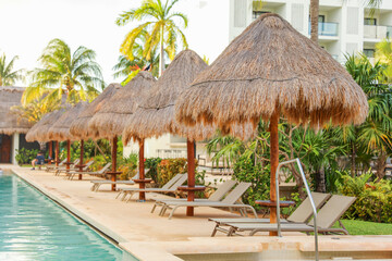 palapa sun roof beach umbrella by the beach symbolizes relaxation, shade, and protection. It represents a tropical, beachy atmosphere and the desire to escape from the sun's harsh rays