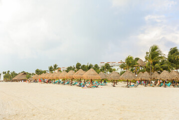 palapa sun roof beach umbrella by the beach symbolizes relaxation, shade, and protection. It represents a tropical, beachy atmosphere and the desire to escape from the sun's harsh rays