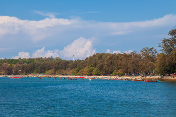 Fototapeta premium Rawai beach in thailand on the island of phuket with old fishing wooden boats with long ropes moored to the shore.