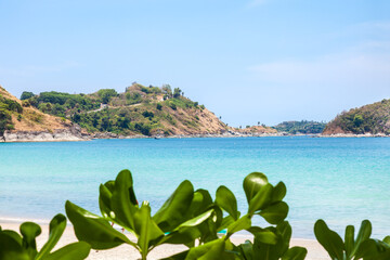 beautiful bright nai harn beach in thailand on phuket island with clear turquoise water in the sea, white sand and blue sky. A popular tourist place in the hot countries of Asia.