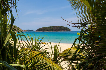 beautiful bright nai harn beach in thailand on phuket island with clear turquoise water in the sea, white sand and blue sky. A popular tourist place in the hot countries of Asia.