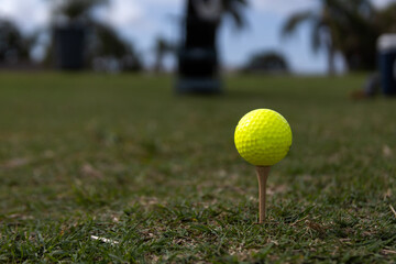 Golf ball on tee. Shallow depth of field. Focus on ball.