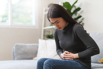 close up woman suffering stomach pain from food poisoning.