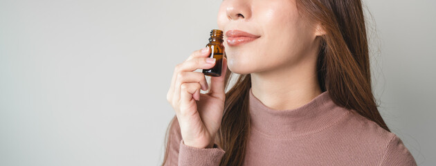 close-up view person test smelling aroma essential oil in the bottle for diffuser