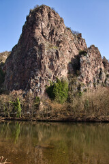 Fototapeta na wymiar Rock cliff behind the Nahe River in Bad Kreuznach, Germany on a sunny winter day.