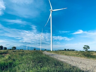 Wind turbines on a dirt road in the countryside