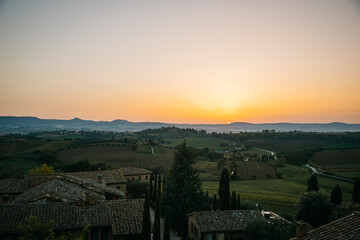 Beautiful and colorful orange sunset in Tuscany, Italy fields