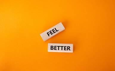 Feel better symbol. Wooden blocks with words Feel better. Beautiful orange background. Business and Feel better concept. Copy space.