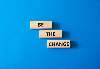 Be the change symbol. Concept word Be the change on wooden blocks. Beautiful blue background. Business and Be the change concept. Copy space